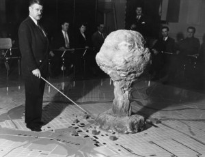 Atomic Defence: The commandant of the Civil Defence Technical Training Centre in Quebec demonstrates the effect of an atomic bomb exploding over a city, Canada, 28th April 1952. (Photo by Hulton Archive/Getty Images)